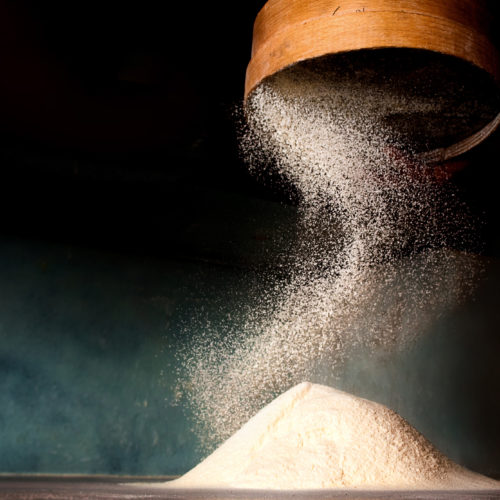 Sifting flour from old sieve for make pizza.